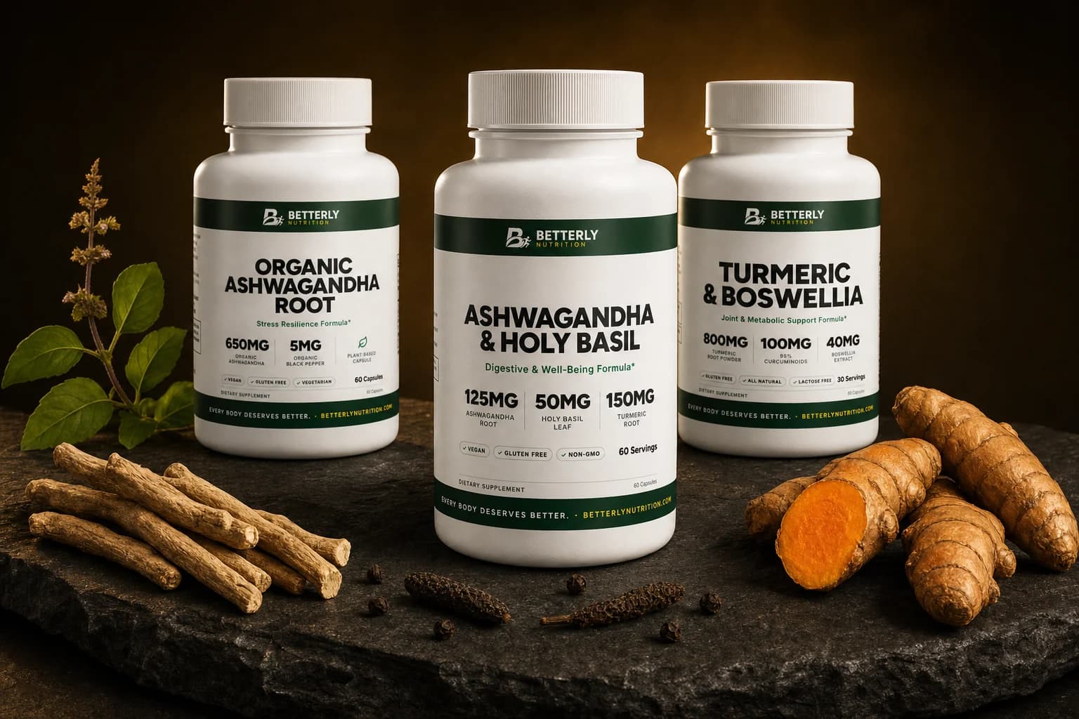 Three Betterly bottles, Ashwagandha & Holy Basil in front, on a dark stone slab with dried ashwagandha roots, basil and cut turmeric