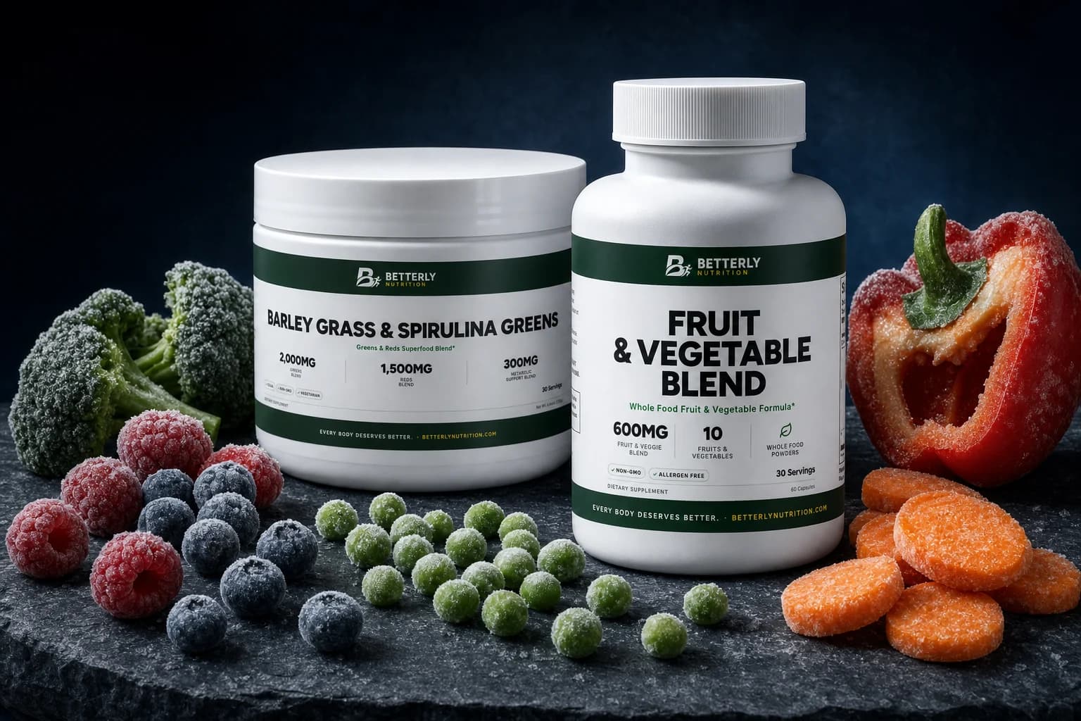 Fruit & Vegetable Blend bottle and Barley Grass & Spirulina Greens tub on dark slate with frosted berries, peas, broccoli and carrots