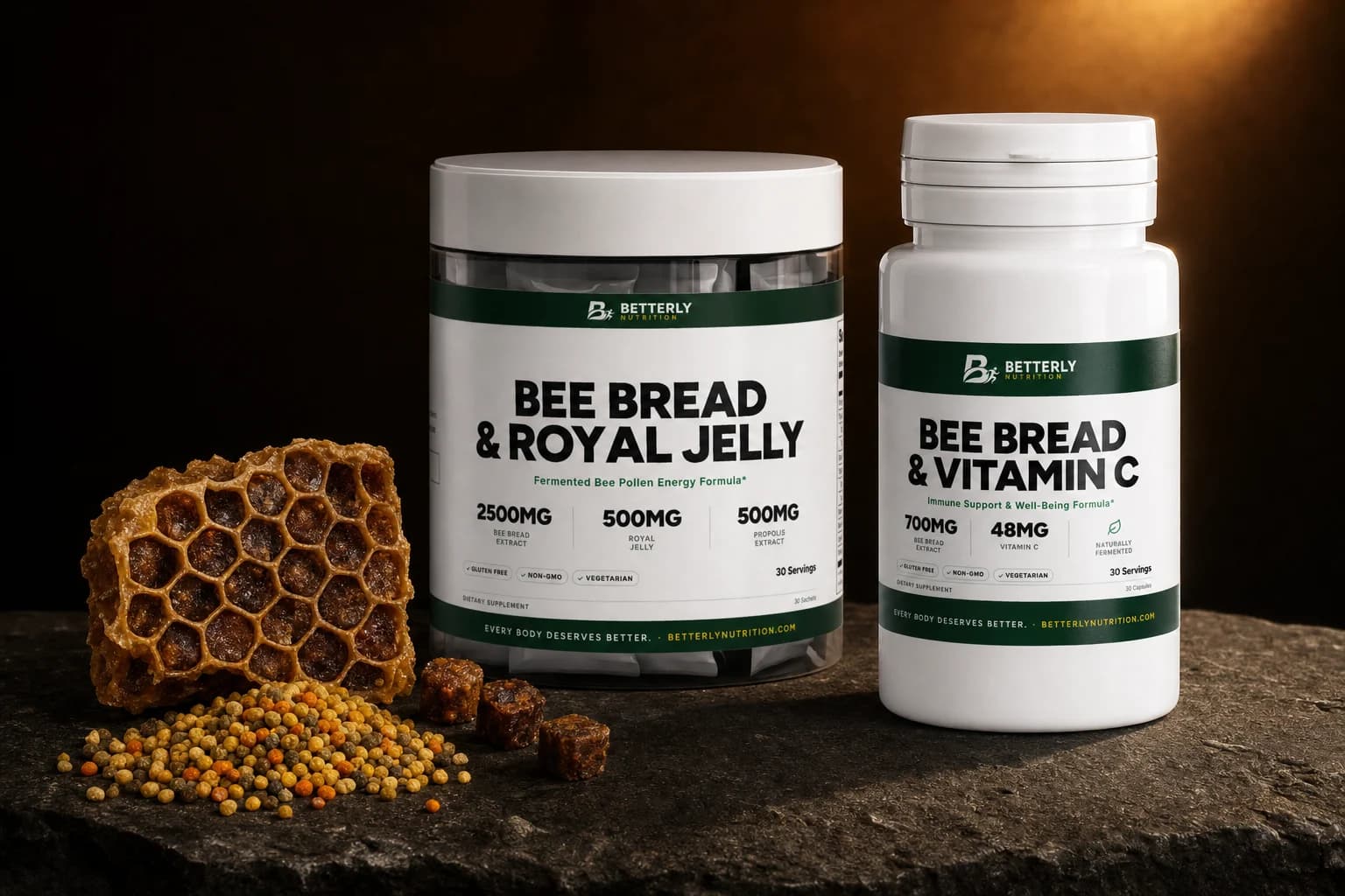 Bee Bread & Royal Jelly tub and Bee Bread & Vitamin C bottle on dark stone beside honeycomb, bee pollen pellets and bee bread cubes