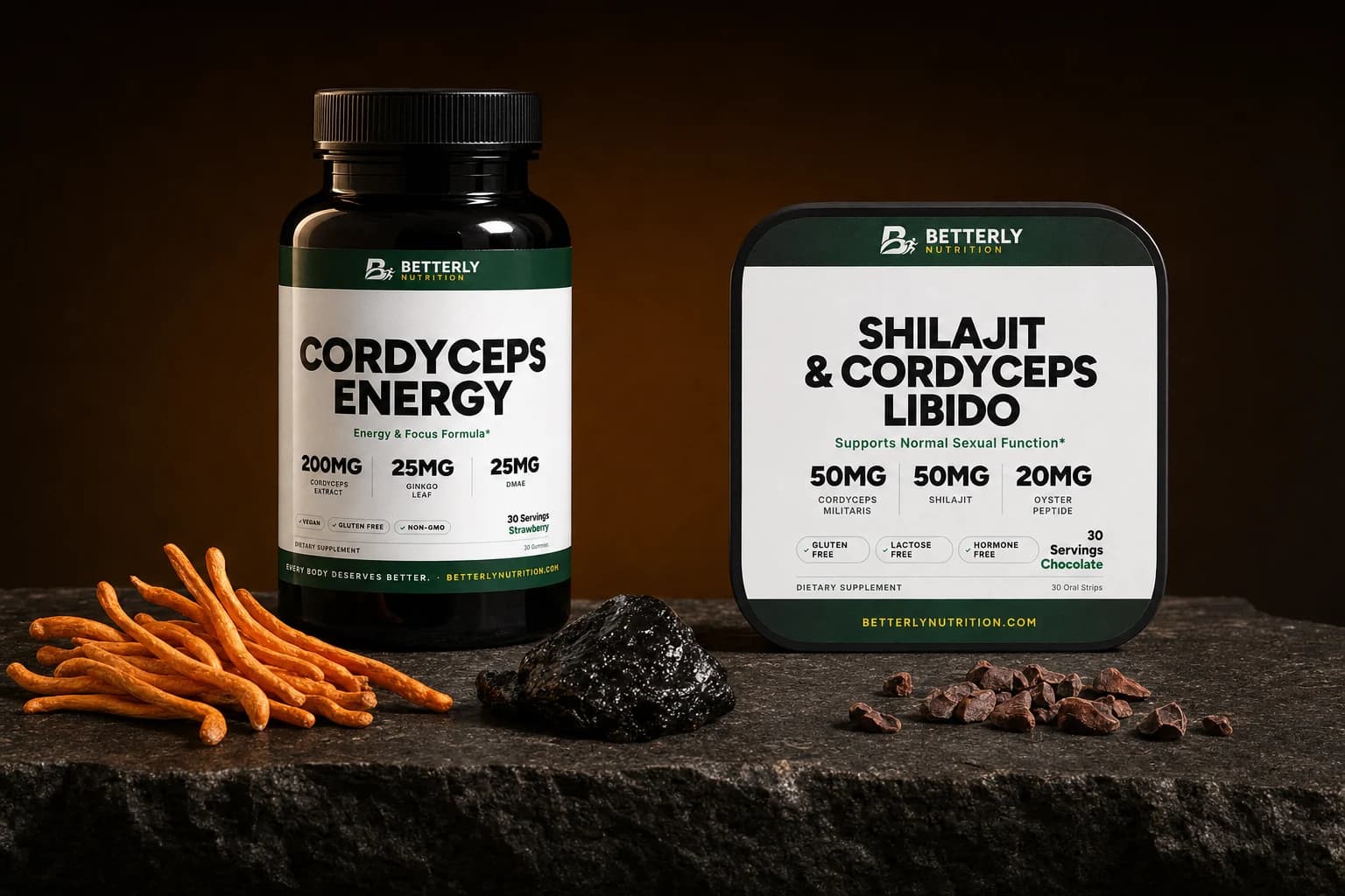Cordyceps Energy gummy bottle and Shilajit & Cordyceps Libido tin on dark stone beside orange cordyceps, shilajit resin and cacao nibs