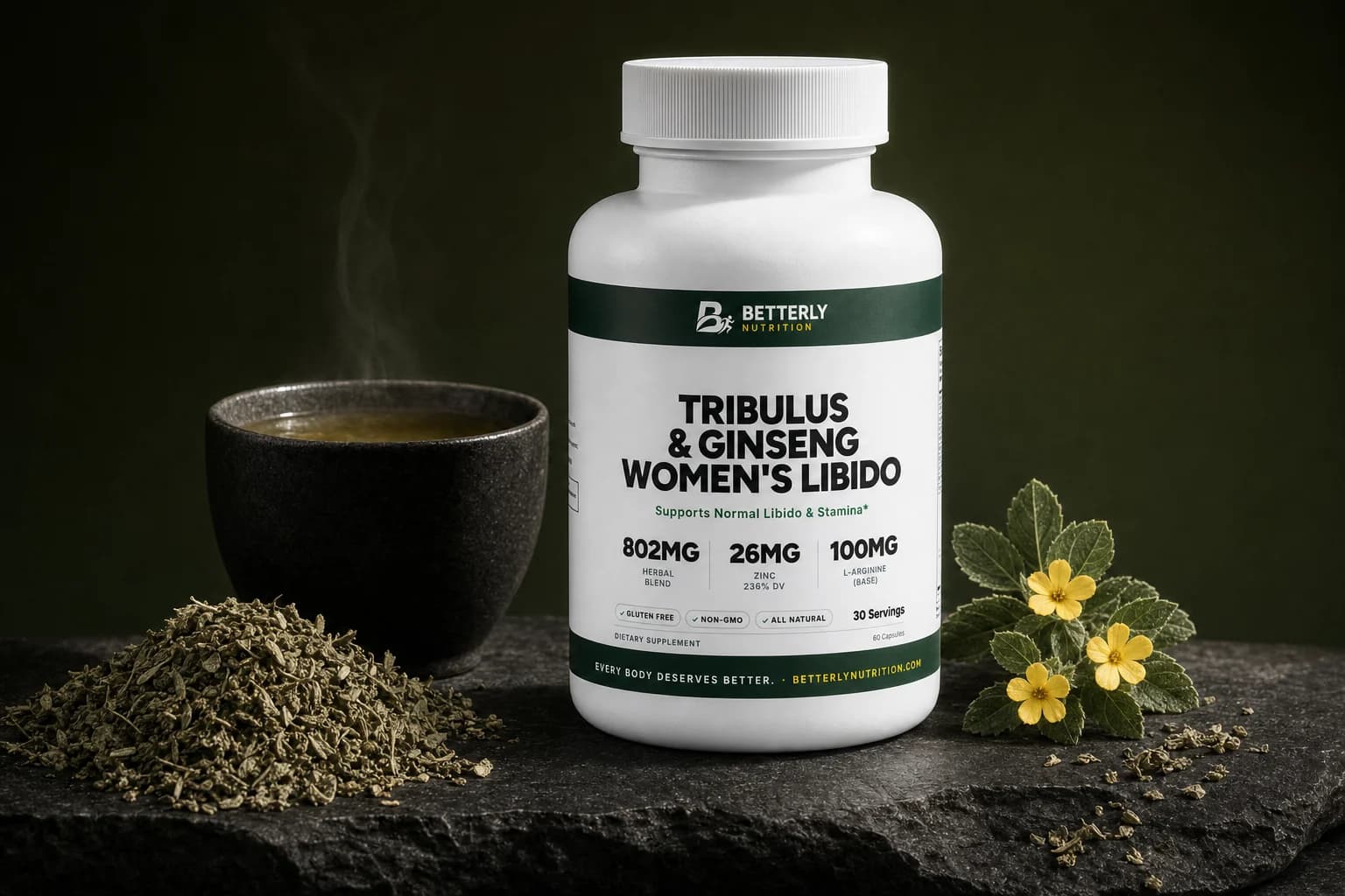 Tribulus & Ginseng Women's Libido Capsules bottle on dark stone by a cup of tea, dried damiana leaves and a yellow-flowered sprig