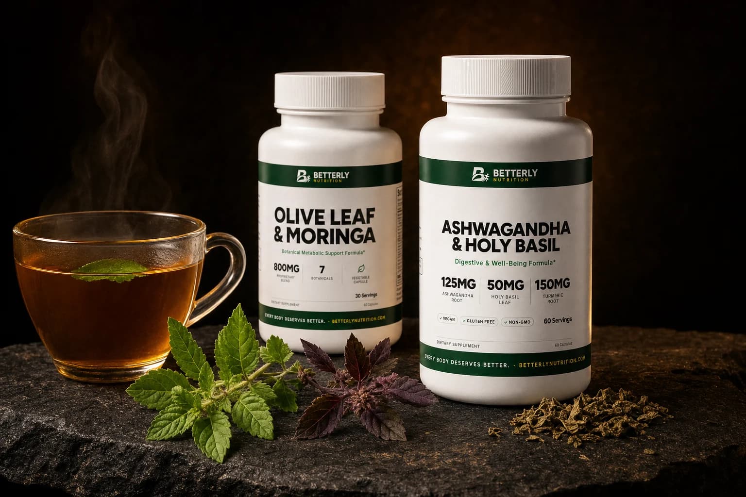 Olive Leaf & Moringa and Ashwagandha & Holy Basil bottles on dark stone with a glass cup of amber tea and green and purple tulsi
