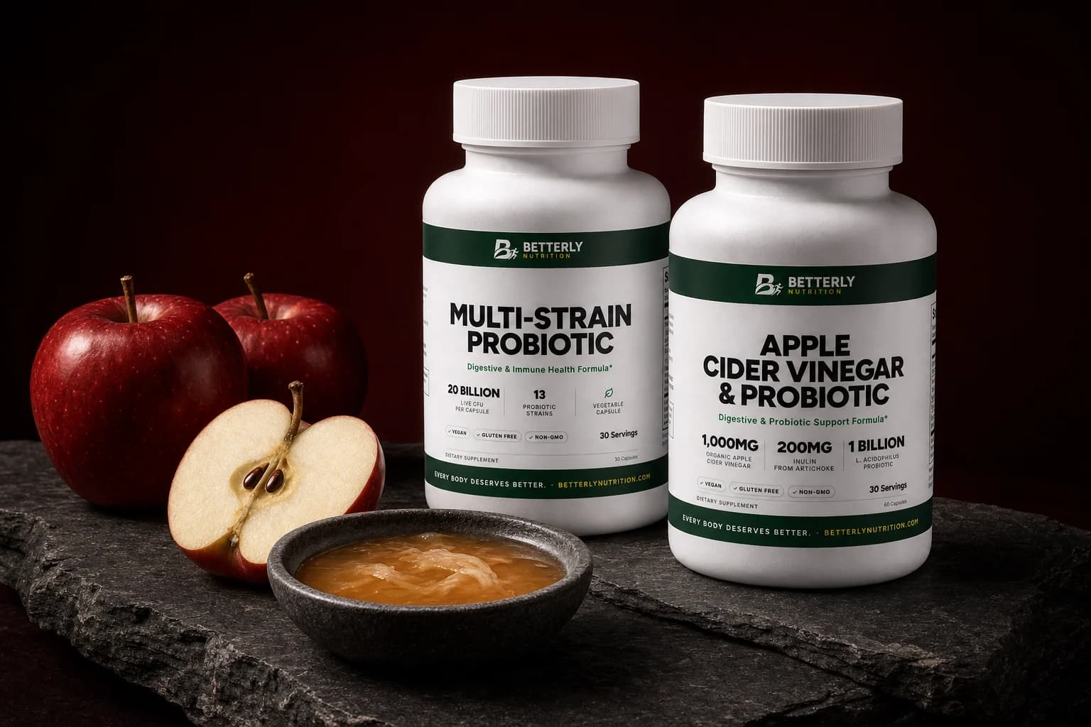 Multi-Strain Probiotic and Apple Cider Vinegar & Probiotic bottles on dark slate beside red apples, a cut apple and a bowl of amber vinegar