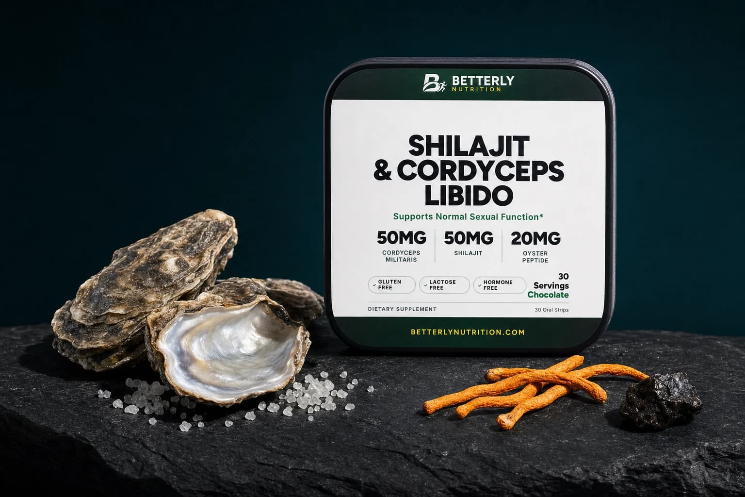 Shilajit & Cordyceps Libido tin on a rough slate slab beside oyster shells, a pearly open half-shell, sea salt, cordyceps and shilajit