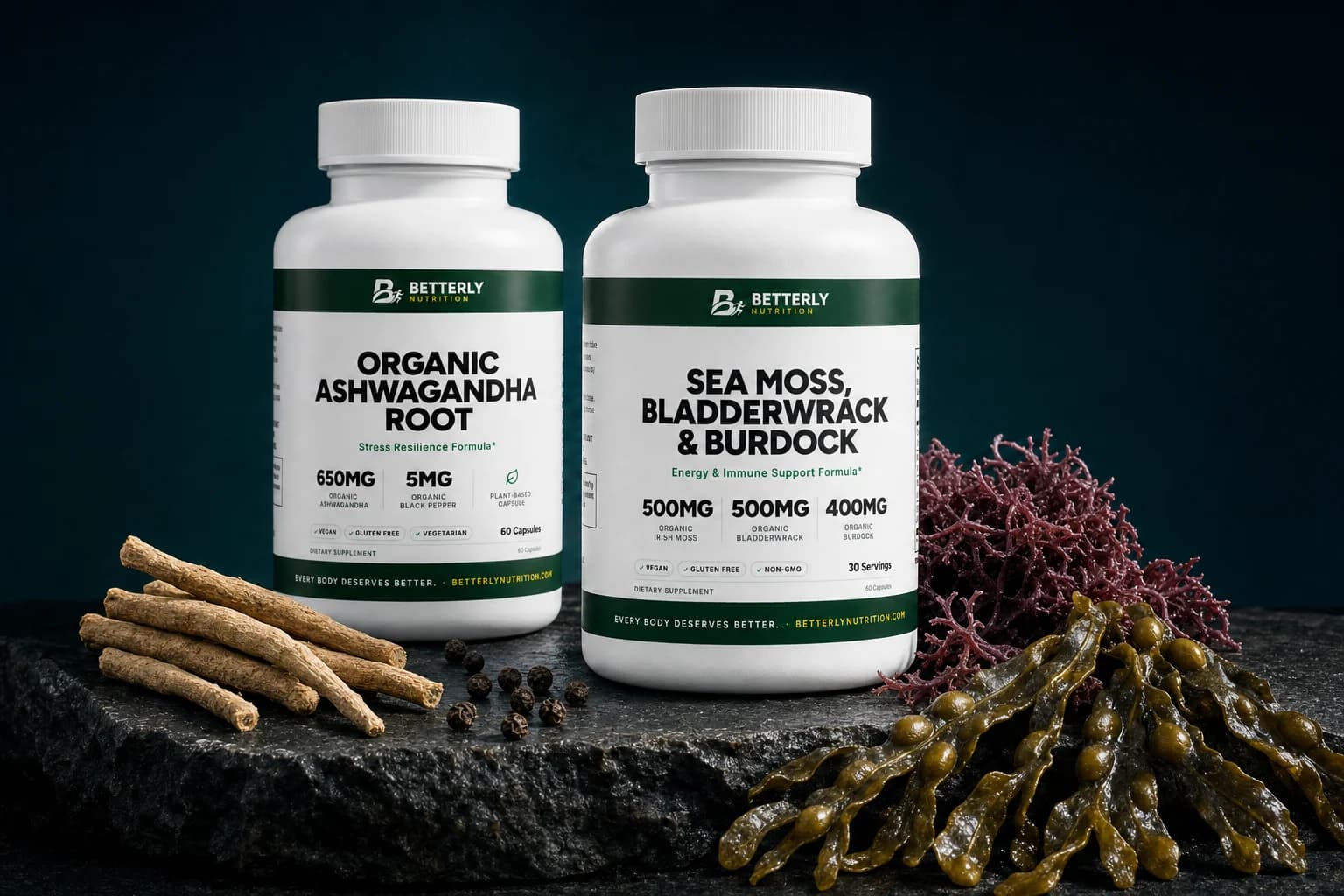 Ashwagandha Root and Sea Moss, Bladderwrack & Burdock bottles on dark stone with dried roots, peppercorns, red moss and bladderwrack