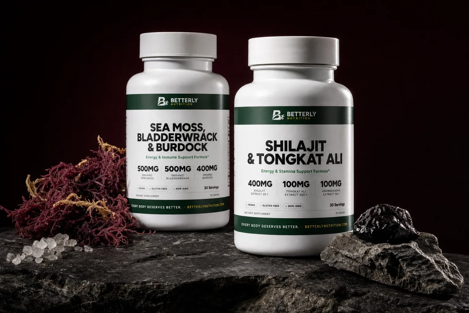 Sea Moss, Bladderwrack & Burdock and Shilajit & Tongkat Ali bottles on dark slate with red seaweed, sea salt and black resin on a rock