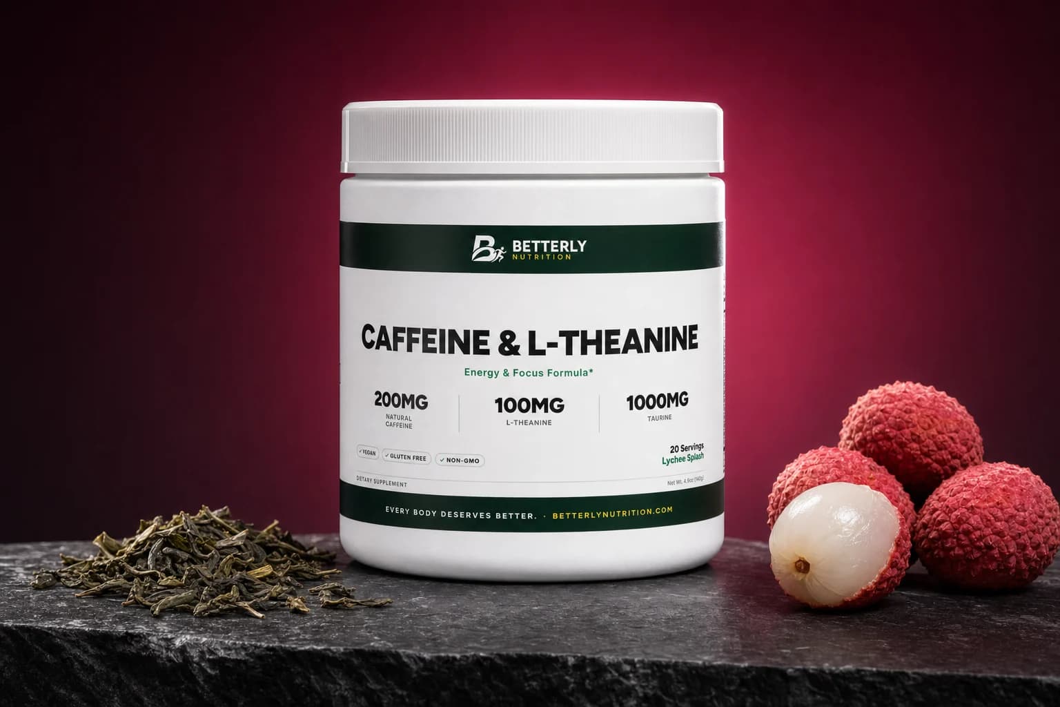 Caffeine & L-Theanine Energy Powder (Lychee Splash) tub on dark stone with green tea leaves, whole and peeled lychees, pink backdrop