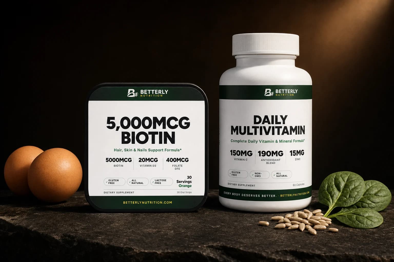 5,000mcg Biotin Strips tin and Daily Multivitamin Capsules bottle on dark stone beside two brown eggs, sunflower seeds and spinach