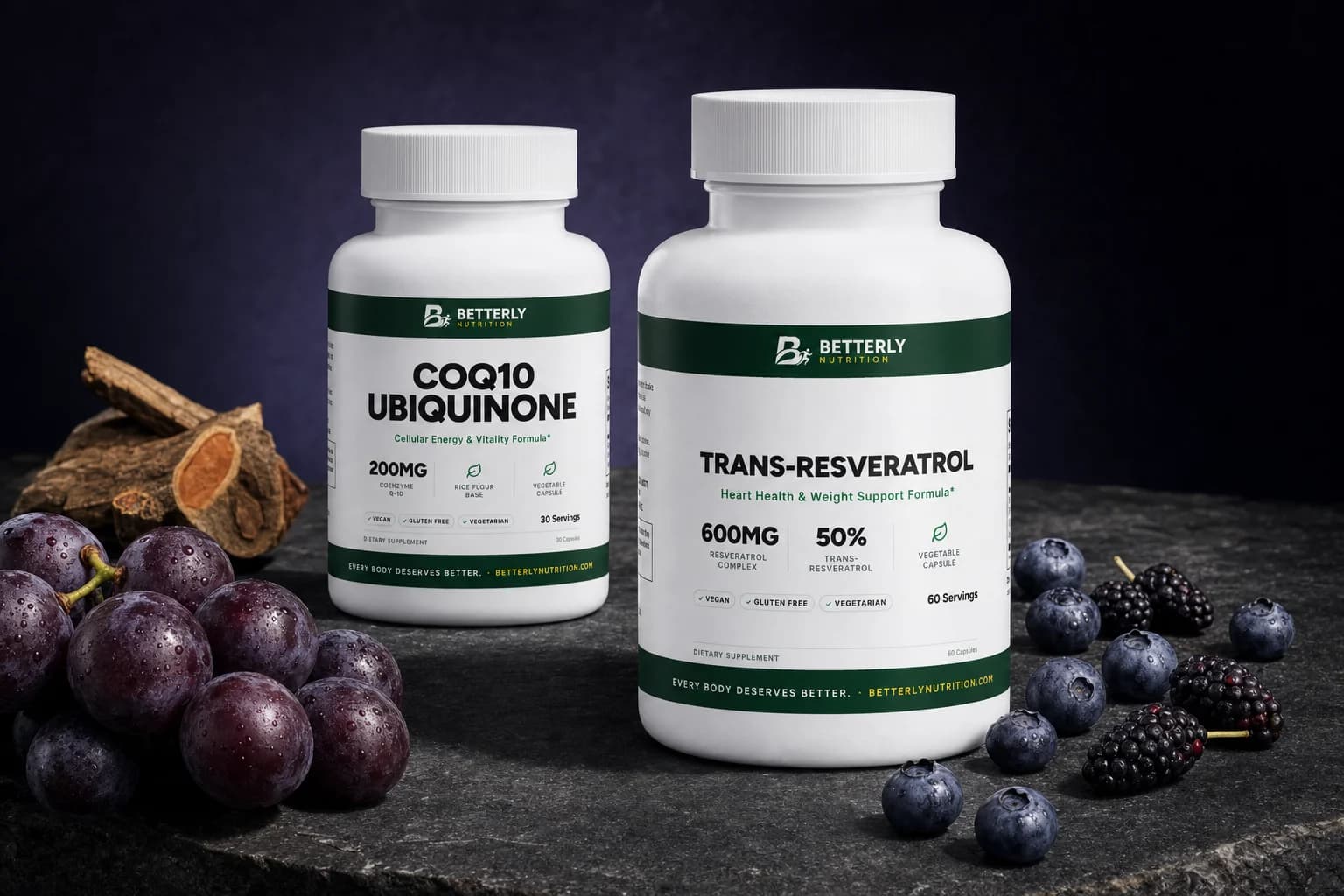 Trans-Resveratrol and CoQ10 Ubiquinone bottles on dark stone beside purple grapes, split knotweed root, blueberries and mulberries
