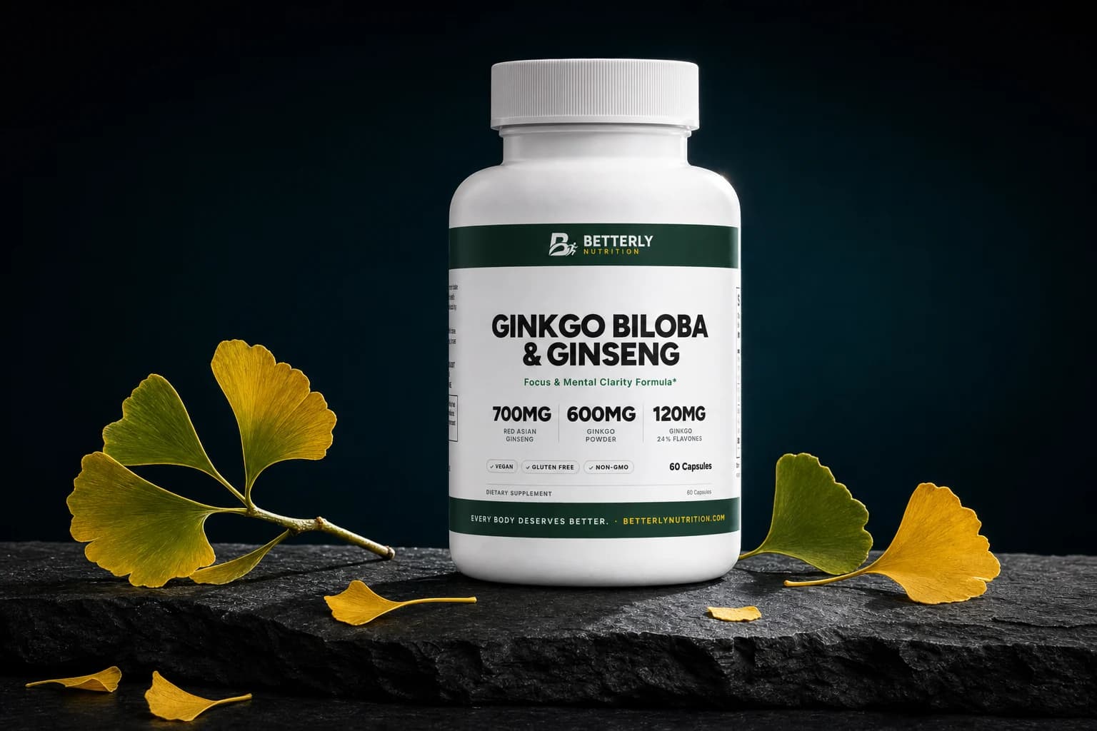 Ginkgo Biloba & Ginseng Capsules bottle on dark slate, a ginkgo twig at left, one green and one gold leaf at right, gold leaves in front