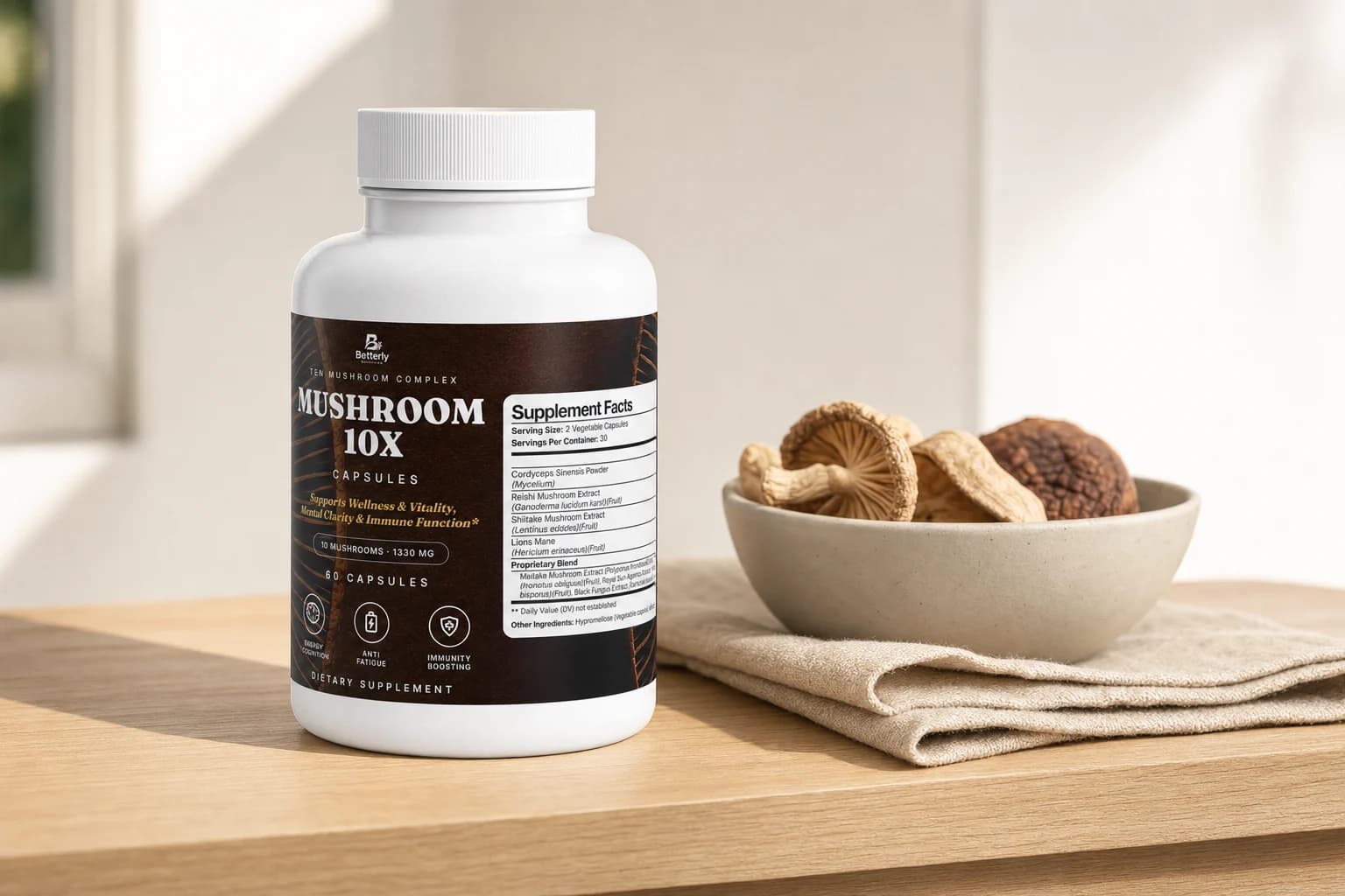 Betterly Mushroom Complex 10 X bottle on a pale oak shelf beside a small bowl of dried mushrooms