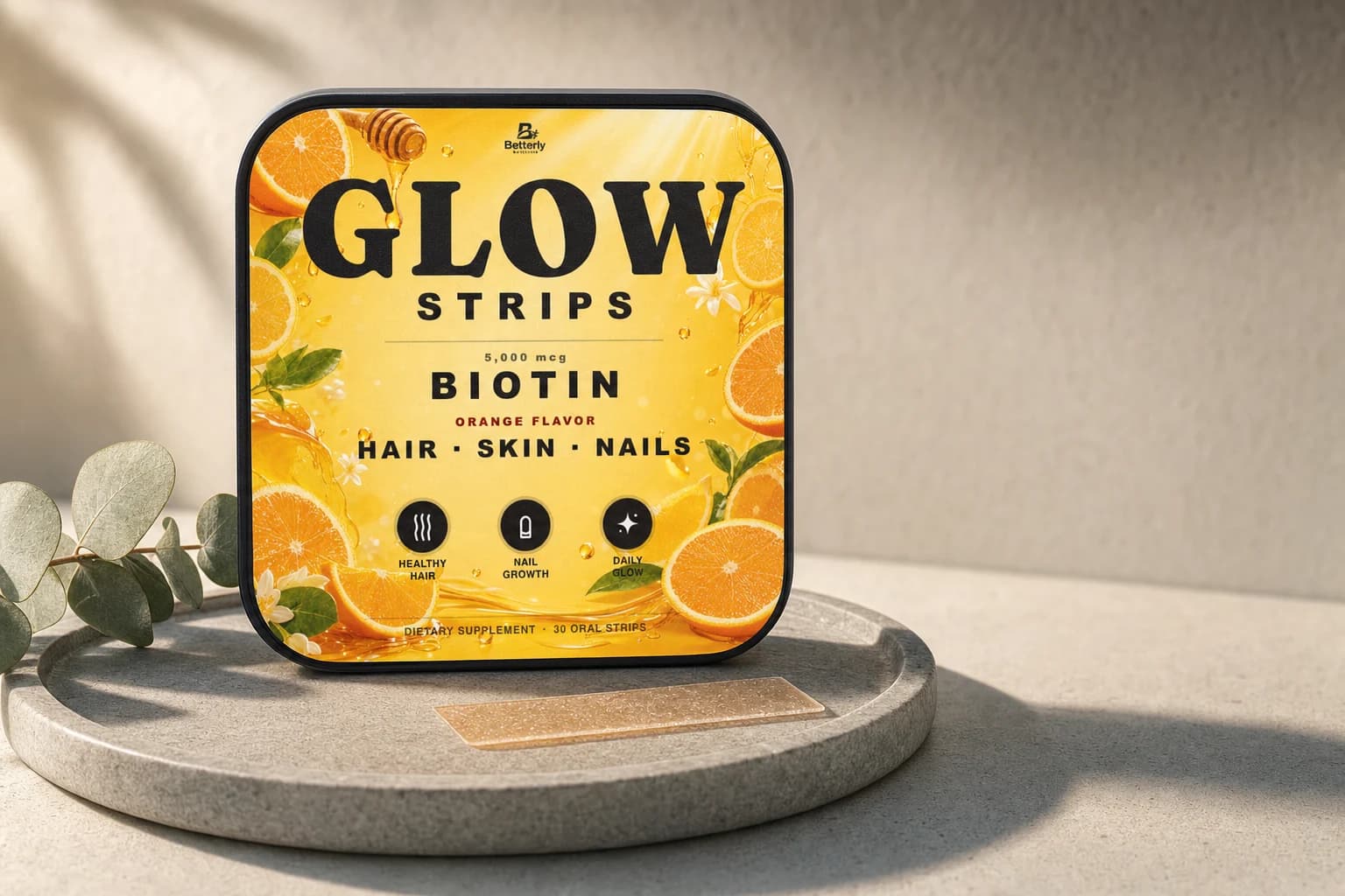 Betterly Hair, Skin and Nails Strips carton on a grey stone tray with one dissolvable strip and eucalyptus