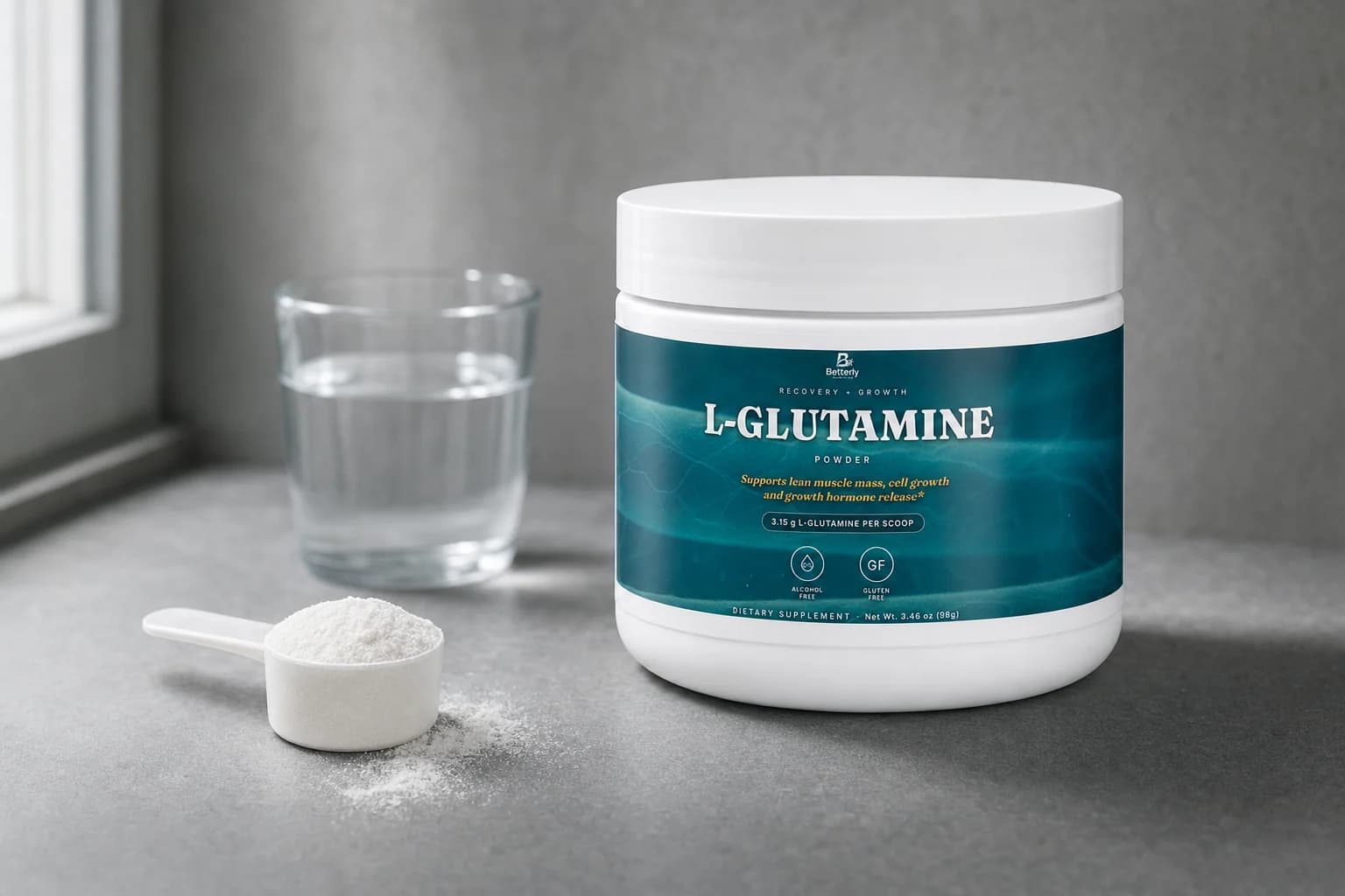 Betterly L-Glutamine powder tub on a slate countertop beside a level scoop of white powder