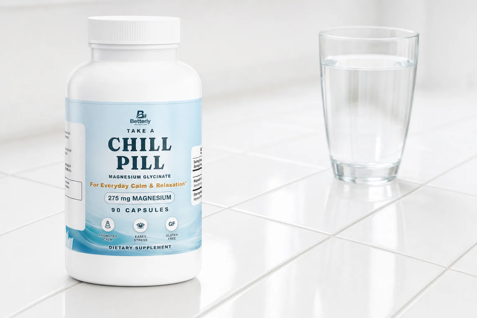 Magnesium Glycinate bottle on a white tile counter beside a clear glass of water